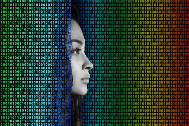 Woman's face emerging from binary code